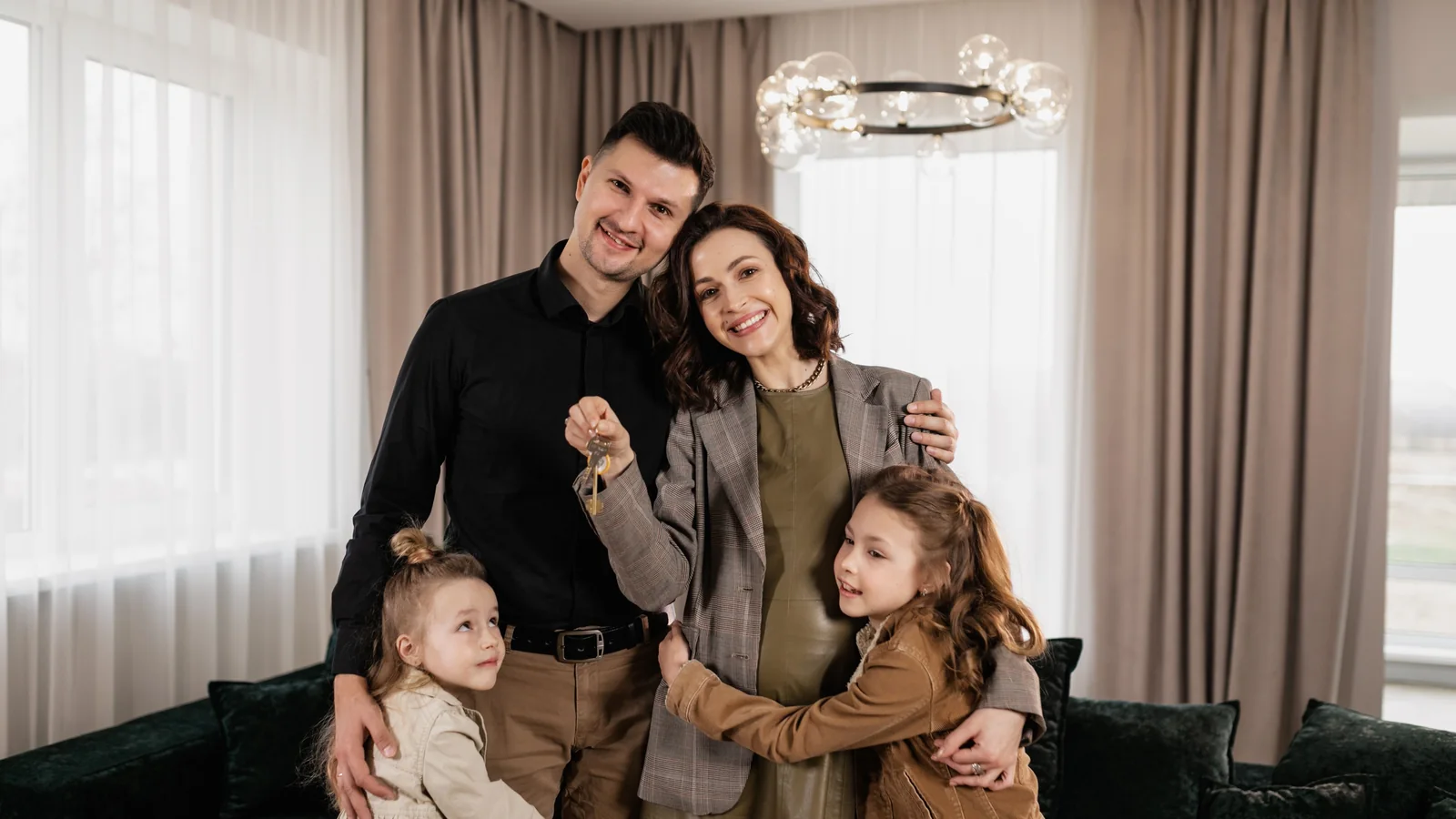 Une famille réunie dans son nouveau logement montre les clés de la maison