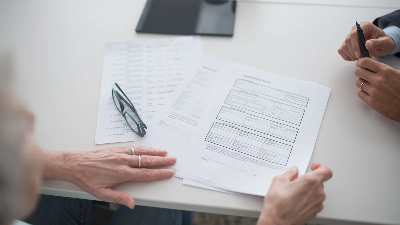 Des personnes examinent ensemble des documents liés à une succession et à son calcul fiscal